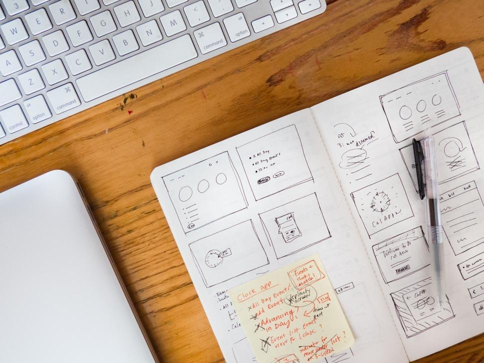 UX/UI design workspace — wireframe sketches and devices